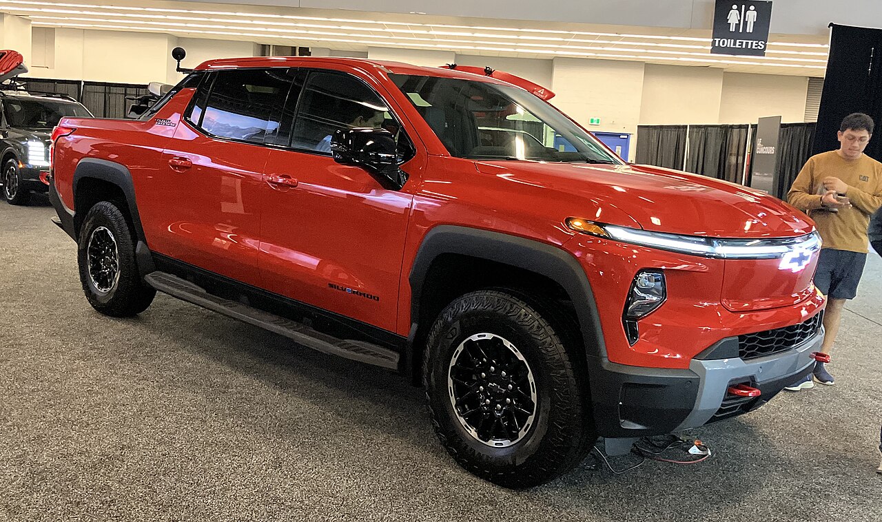 Archive photo of a red 2026 Chevrolet Silverado EV on display indoors at the Montréal International Auto Show.
