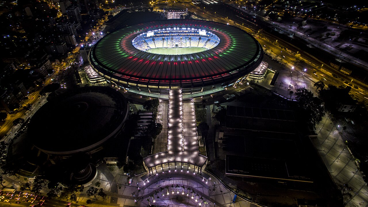 Archive nighttime aerial view of Maracanã Stadium illuminated above the surrounding streets of Rio de Janeiro.